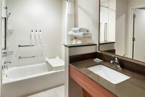 a bathroom with a sink and a tub and a toilet at Fairfield by Marriott Inn & Suites Grovetown in Grovetown
