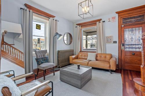 a living room with a couch and a chair at Luxury 8 Bedroom House, Steps to Tropicana, Beach and Boardwalk! in Atlantic City