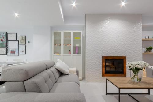 a living room with a couch and a fireplace at The Sunset Flat - Design & relax in Elche