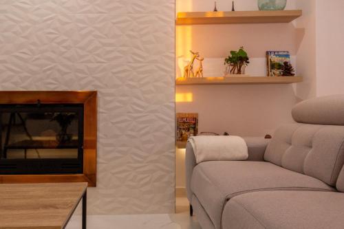 a living room with a couch and a fireplace at The Sunset Flat - Design & relax in Elche
