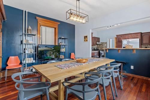 a dining room with a wooden table and chairs at Luxury 8 Bedroom House, Steps to Tropicana, Beach and Boardwalk! in Atlantic City