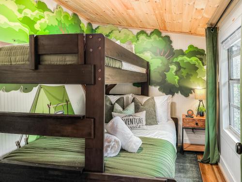 a bedroom with a bunk bed with a green wall at 200ft Fightingtown Creek Frnthot Tubarcd in Blue Ridge