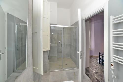 a glass shower in a bathroom with purple walls at L'antico molino in Foligno