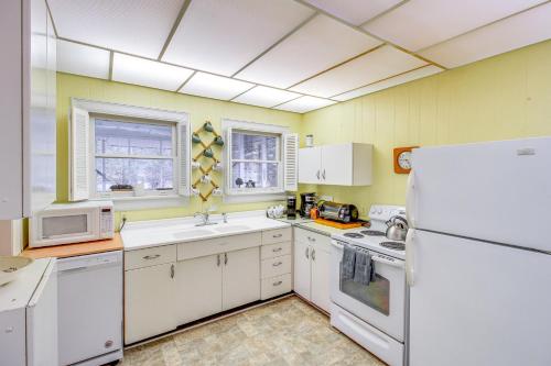 a kitchen with white appliances and a white refrigerator at Central and Ornate Sewanee Home with Screened-In Porch in Sewanee