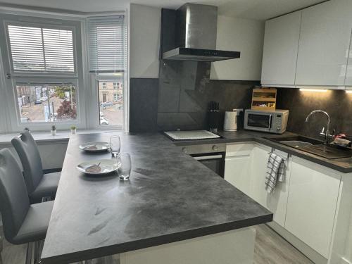 a kitchen with a counter top with a microwave at Stonehaven Centre - Fetteresso Apartment in Stonehaven