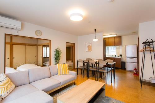 a living room with a couch and a table at ObihiroINN - Vacation STAY 18480 in Obihiro