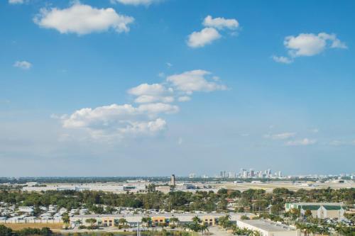 a view of a city with a blue sky and clouds at AC Hotel by Marriott Fort Lauderdale Airport in Dania Beach