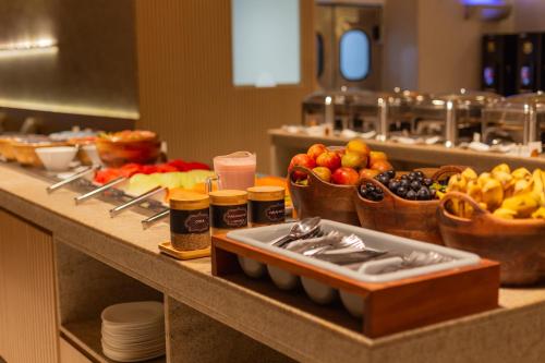 a buffet with fruits and other foods on a counter at Ritz Suites Grand Hotel Boutique in Maceió