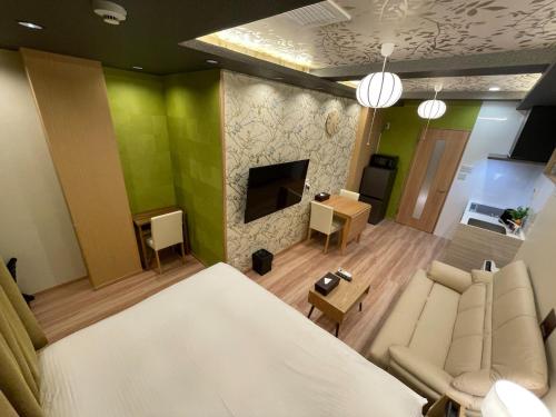 a bedroom with a bed and a living room with green walls at Haneda KS Building 2F 3F - Vacation STAY 23748v in Tokyo
