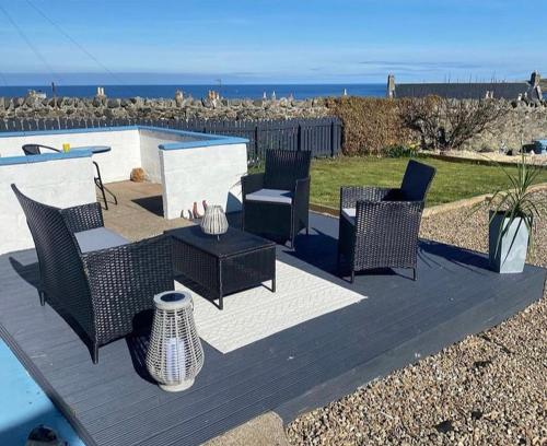 a patio with chairs and a table and a tablektop at Number Forty Two, Portsoy - A 3 bedroom cottage with sea views in Portsoy