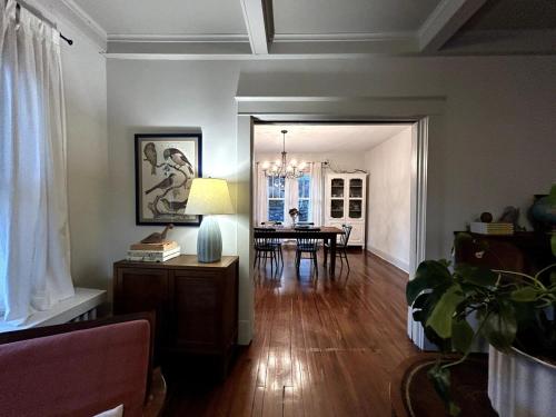 a living room with a table and a dining room at The Farmhouse at Fort Hill in Peekskill