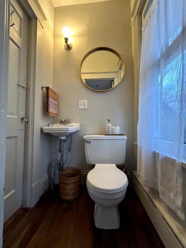 a bathroom with a white toilet and a sink at The Farmhouse at Fort Hill in Peekskill