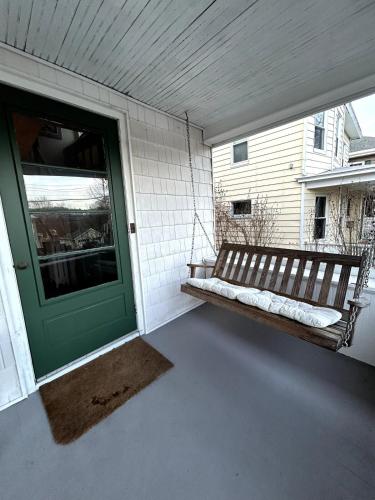 a porch with a bench next to a door at The Farmhouse at Fort Hill in Peekskill