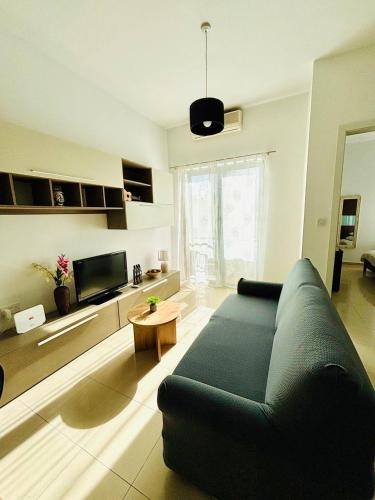 a living room with a couch and a table at Sea side beautiful One bedroom apartment in St Julian's