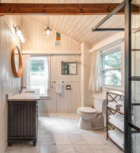 a bathroom with a toilet and a sink at Stay at Little River in Gloucester