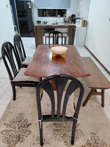 a wooden table and chairs in a kitchen at D Banyan Homestay, Bukit Banyan in Sungai Petani