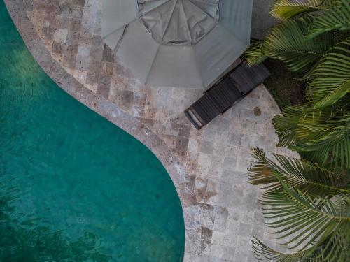 an overhead view of a pool with an umbrella and chairs at Comfort Inn Puerto Vallarta Golfside & Marina in Puerto Vallarta