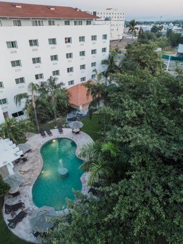 an overhead view of a swimming pool in front of a building at Comfort Inn Puerto Vallarta Golfside & Marina in Puerto Vallarta