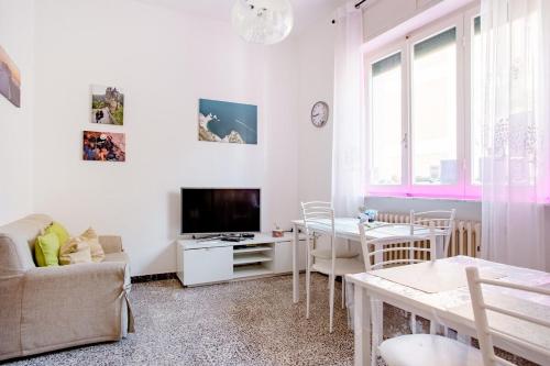a living room with a couch a table and a tv at CASA MAFALDA - Rooms, friends and more - Affittacamere, Guest House in Senigallia