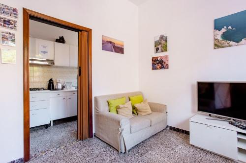a living room with a couch and a television at CASA MAFALDA - Rooms, friends and more - Affittacamere, Guest House in Senigallia
