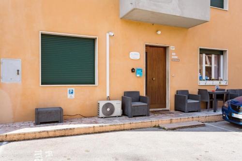 a building with chairs and a tv and a table at CASA MAFALDA - Rooms, friends and more - Affittacamere, Guest House in Senigallia