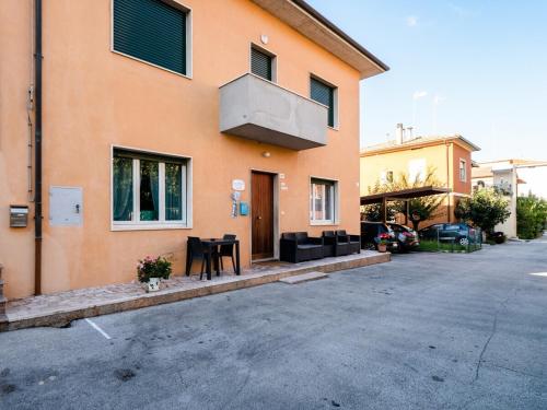 a orange building with a table in front of it at CASA MAFALDA - Rooms, friends and more - Affittacamere, Guest House in Senigallia