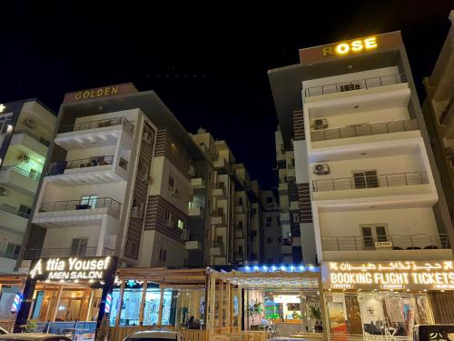 two tall buildings in a city at night at Hurghada apartment luxury 001 in Hurghada