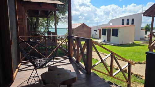 a balcony with a wooden railing and a view of the ocean at bacalar My Love Front Laguna in Bacalar