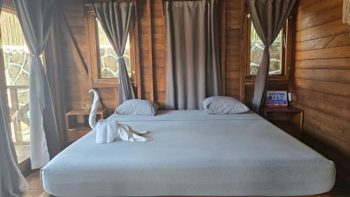 a bedroom with a bed with two swans on it at bacalar My Love Front Laguna in Bacalar