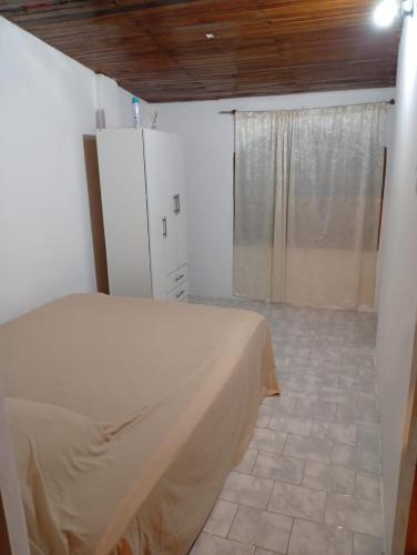 a bedroom with a bed and a shower in it at San Miguel in Formosa