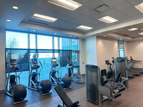 a gym with treadmills and exercise bikes in a building at Embassy Suites by Hilton Kansas City Olathe in Olathe