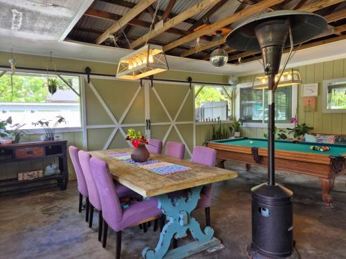 a dining room with a table and a pool table at Pu'uwai Place of Volcano Village in Volcano