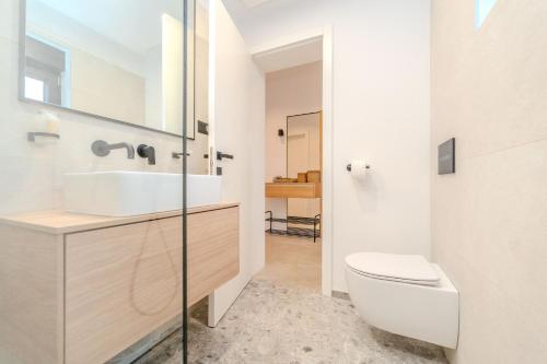 a bathroom with a sink and a toilet at Beachfront Villa Jugo with Seaview in Privlaka