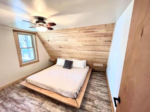 a bed in a room with a ceiling at LakeFire Cabin in Eufaula