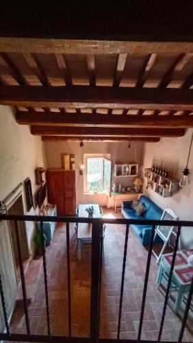 a room with a bed and a living room at Appartamento nel Borgo Cuore dell'Umbria, vicino ad Assisi in Gualdo Cattaneo