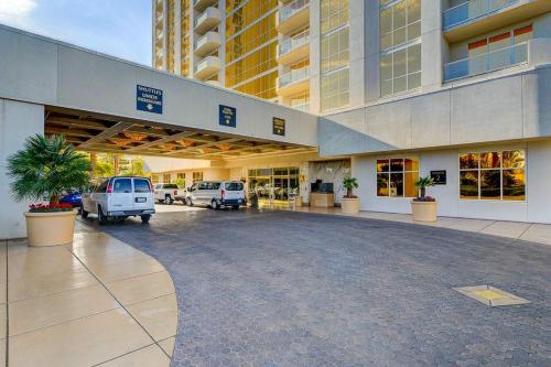 a large building with vehicles parked in a parking lot at MGM Signature-22-615 Strip View Balcony Studio in Las Vegas