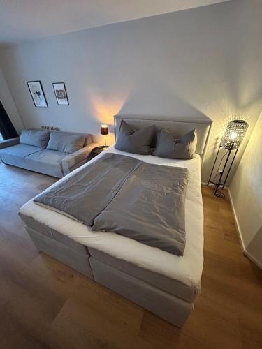 a bedroom with a large bed and a couch at Apartment in Obernzell in Obernzell