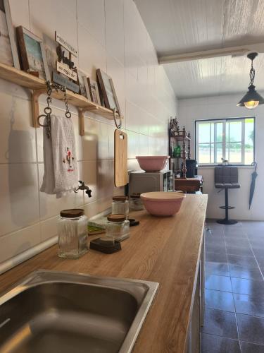 a kitchen with a sink and a wooden counter top at Quinta do Lidador in Chamusca