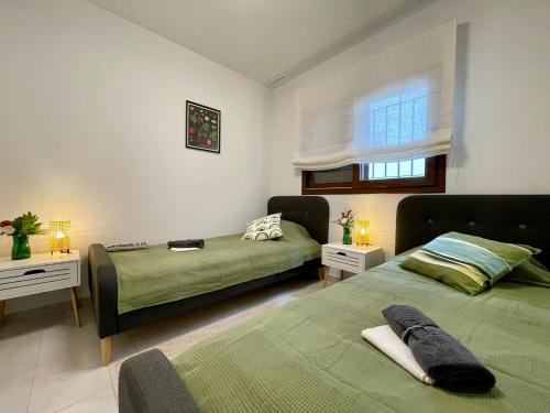 a bedroom with two beds and a window at Casa Arona in San Juan de los Terreros