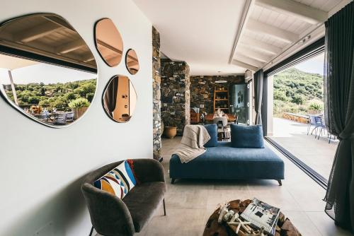 a living room with a blue couch and a mirror at BLUVARI' Charming House in Alassio