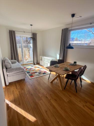 a living room with a table and a couch at Bestezeit Appartements in Schladming
