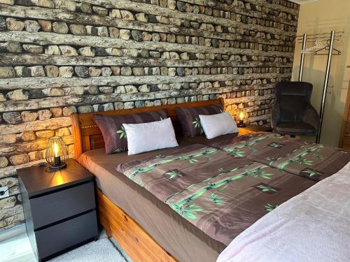 a bed in a room with a brick wall at Villa Black Sea in Balchik