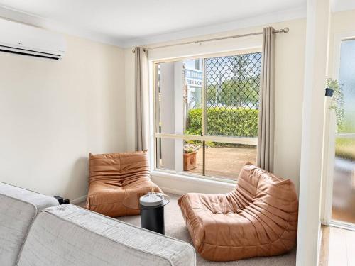 a living room with two couches and a window at Beach Front Holiday Home with Pool, Prime Location in Clontarf