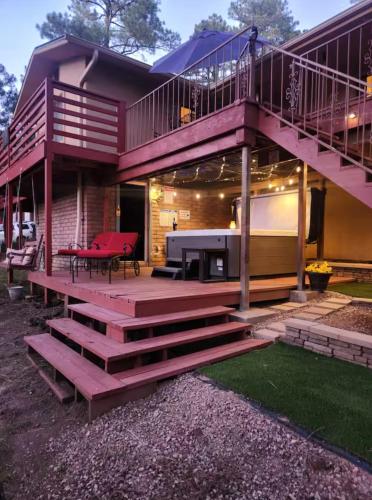 a house with a staircase leading up to a deck at Chic Country Home in the Woods with Hot Tub in Ruidoso