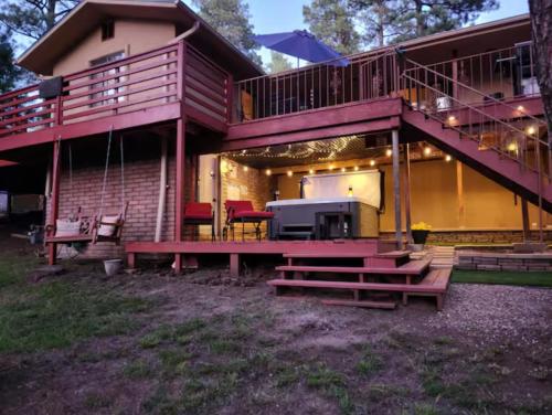 a large house with a deck and a patio at Chic Country Home in the Woods with Hot Tub in Ruidoso