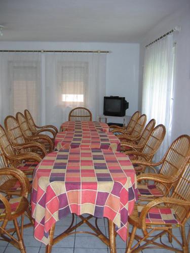 a dining room with a large table and chairs at Barzsó Vendégház in Bogács