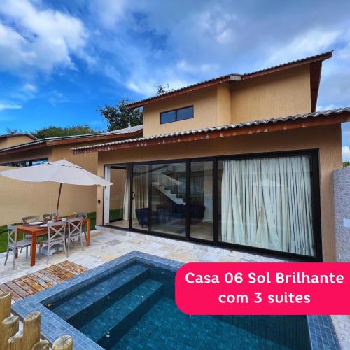 a villa with a swimming pool in front of a house at Fontes da Pipa by Liiv in Pipa