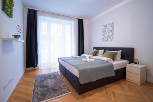 a bedroom with a bed and a large window at Home Sweet Home - State Opera in Vienna