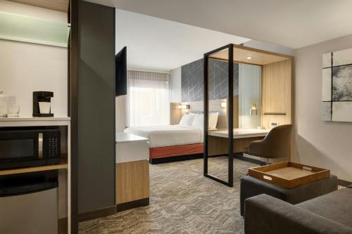 a hotel room with a bed and a living room at SpringHill Suites by Marriott Easton PA in Easton