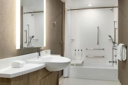 a bathroom with a sink and a tub and a shower at SpringHill Suites by Marriott Easton PA in Easton